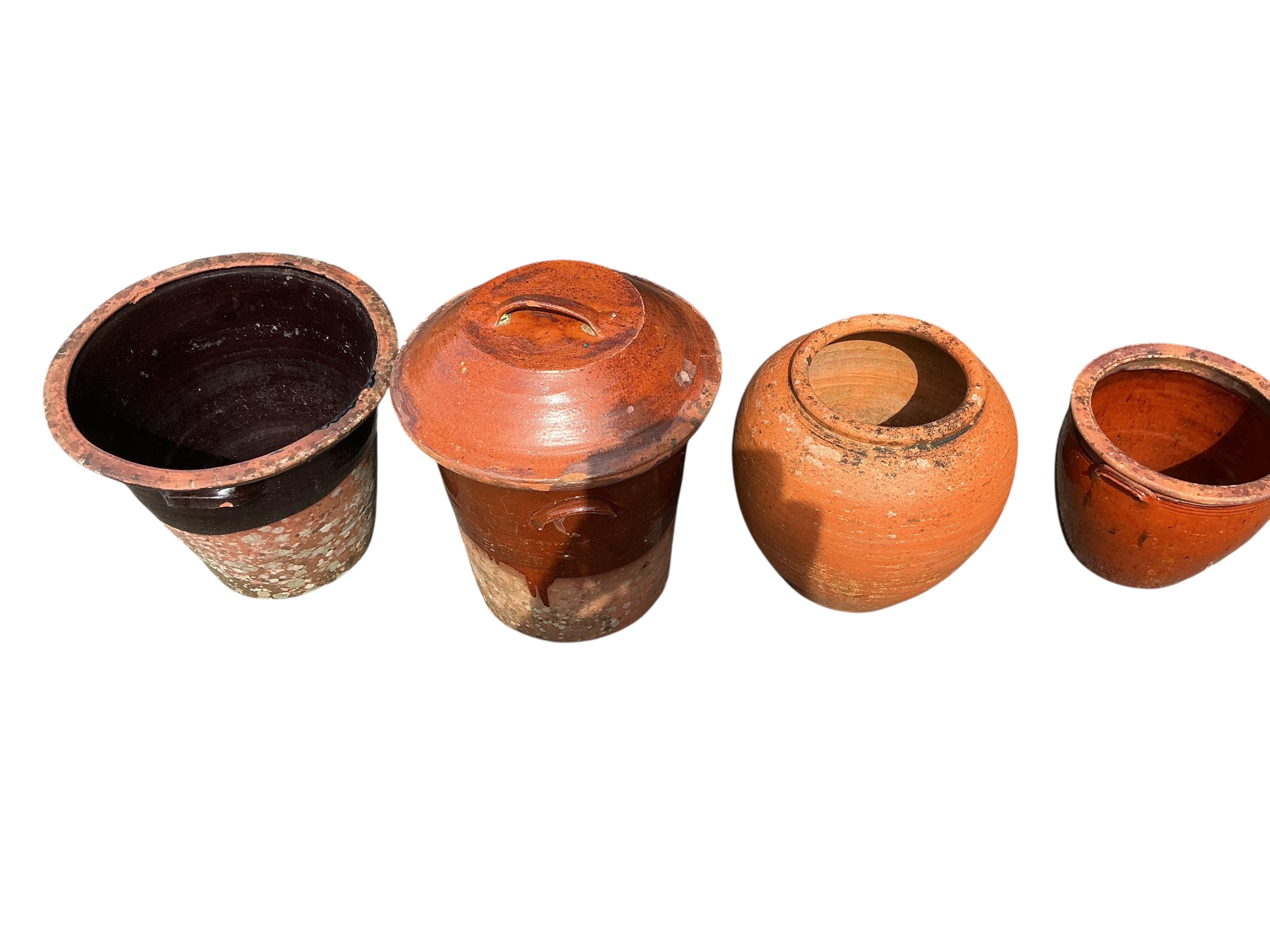 Four circular earthenware pails and planters, largest height 50cm